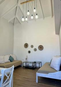 a living room with two beds and a table at House Katholiki in Halki