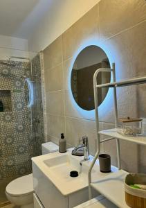 a bathroom with a sink and a toilet and a mirror at House Katholiki in Halki