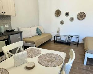 a living room with a table and a couch at House Katholiki in Halki