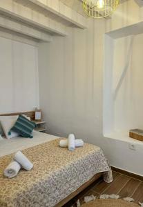 a bedroom with a bed with towels on it at House Katholiki in Halki