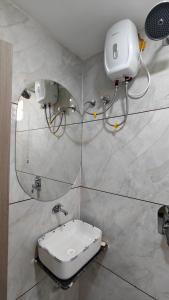 a bathroom with a toilet and a mirror on the wall at Hotel Fortune in Ankleshwar