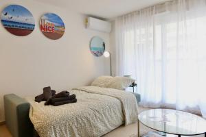 a bedroom with a bed and a glass table at Nice Time - Chic Apartment with sunny terrace, Nice Port in Nice