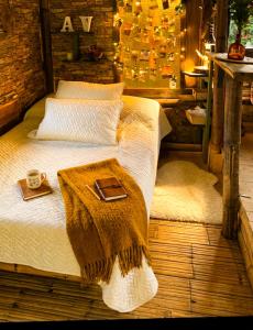 a bed with a blanket and a tray on it at Aldea Victoria EcoRefugio in Medellín +3 photos