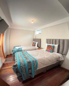 a bedroom with two beds in a room at intikilla hostal in Ollantaytambo