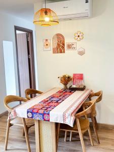 a dining room table with a quilt on it at Rose Home in Lao Cai