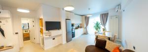 a living room with a couch a table and a kitchen at Eleven Odyssey Apartment in Năvodari