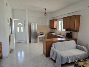 a kitchen with a refrigerator and a chair in it at Nature & Sea Paradise in Analipsi in Análipsis