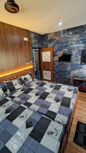 a bedroom with a checkered bed in a room at SIU Elite INN in Chennai