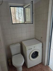 a small bathroom with a toilet and a window at Nature & Sea Paradise in Analipsi in Análipsis