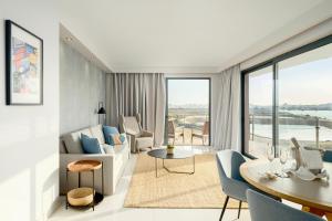 a living room with a couch and a table at Agua Hotels Riverside in Ferragudo