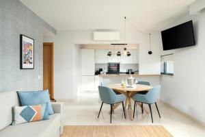 a living room with a table and chairs and a couch at Agua Hotels Riverside in Ferragudo +20 photos