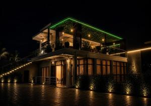 a building with a green roof at night at Cape Town K Hotel in Kigali