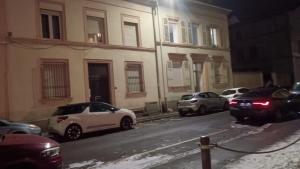 a group of cars parked on a street at night at L horizon bleu in Mulhouse