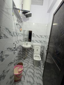 a bathroom with a toilet and a sink at Stay in Someshwar in Varanasi
