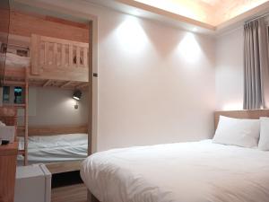 a bedroom with a bed and a bunk bed at Hotel Soda STAY in Seoul