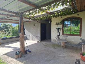 a patio of a house with awning and a window at San Martin in Ibarra