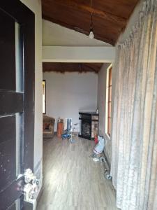 an empty living room with a fireplace and curtains at San Martin in Ibarra