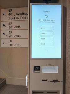 a ticket machine in a hotel room with a sign on it at Hotel Soda STAY in Seoul +29 photos