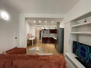 a living room with a bed and a dining room at Priamar house in Savona