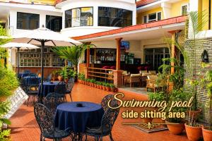 a patio with tables and chairs in a restaurant at Woodland Heritage Hotel in Kathmandu