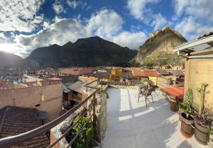 a view of a town with mountains in the background at intikilla hostal in Ollantaytambo