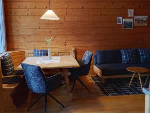 a living room with a table and a couch at Haiderhof in Schleching