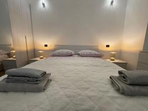 a bedroom with a large bed with pillows on it at Priamar house in Savona +2 photos