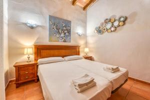 a bedroom with a bed and two night stands and plates on the wall at Finca Cas Padrins in Manacor +35 photos