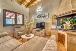 a living room with a couch and a fireplace at Finca Cas Padrins in Manacor