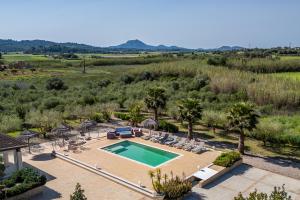 an aerial view of a swimming pool with chairs and trees at Finca Cas Padrins in Manacor