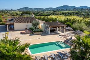 a villa with a swimming pool and a house at Finca Cas Padrins in Manacor