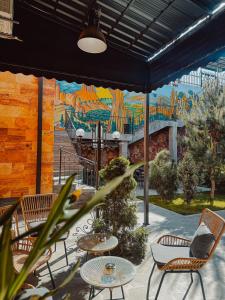 a mural on the side of a building with chairs and tables at Aspar Boutique Hotel in Yerevan