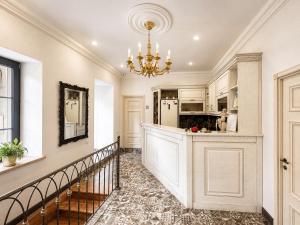 a large kitchen with a staircase and a chandelier at Aspar Boutique Hotel in Yerevan