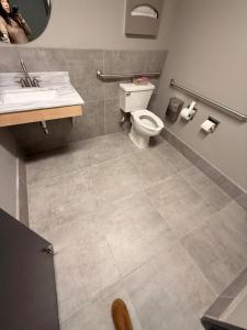 a bathroom with a toilet and a sink at Super 8 by Wyndham Windsor in Windsor
