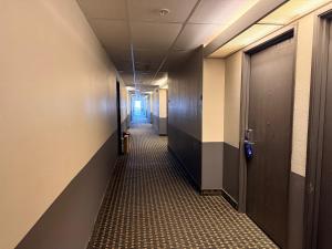 a corridor of a hallway with a long corridorngthngthngthngthngthngthngth at Super 8 by Wyndham Windsor in Windsor +3 photos