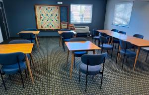 a classroom with tables and chairs in a room at Super 8 by Wyndham Windsor in Windsor