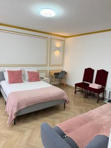 a bedroom with two beds and two chairs at SCI IMMO PARIS PORTE DE CHOISY in Paris