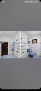 a kitchen with white walls and blue counters at Hotel Manali Villa in Manāli
