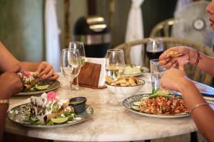 a group of people sitting around a table with plates of food at Terasu Riviera Maya Hotel & Spa, en Xcaret in Playa del Carmen +68 photos