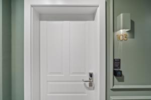 a white door with the number on it at HOME1 - Lumes Boutique Hotel in Vienna +73 photos
