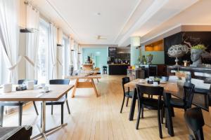 a dining room with wooden tables and chairs at Garner Hotel Friedrichshafen by IHG in Friedrichshafen