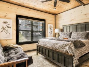 a bedroom with a large bed and a window at Smith Creek Resort - Exclusive Waterpark Included in Sevierville +116 photos