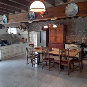a kitchen with a table and chairs and a refrigerator at Chambre d'hôtes Chez Sarah in Saint-Bon +21 photos