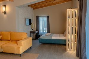 a bedroom with a bed and a couch and a chair at Maria village resort in Pavel Banya +79 photos