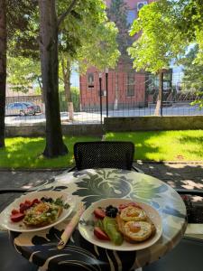 a table with two plates of food on it at Hotel Iseberi in Kukës