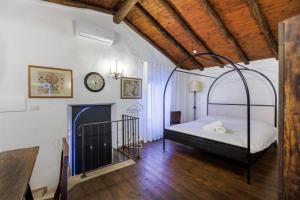 a bedroom with a canopy bed and a fireplace at Borgo Medievale in Castelmola