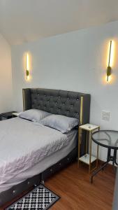 a bedroom with a bed and a glass table at Bann sawnMBNA in Ban Mae Pha Haen