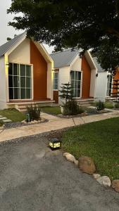 a toy train sitting in front of a house at Bann sawnMBNA in Ban Mae Pha Haen
