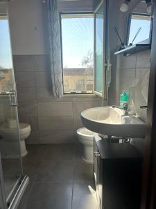 a bathroom with a sink and a toilet and a window at L'Ulivo in Formia +16 photos
