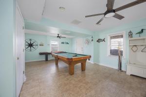 a living room with a pool table in it at 5319 - Day Dreamz in Kill Devil Hills
